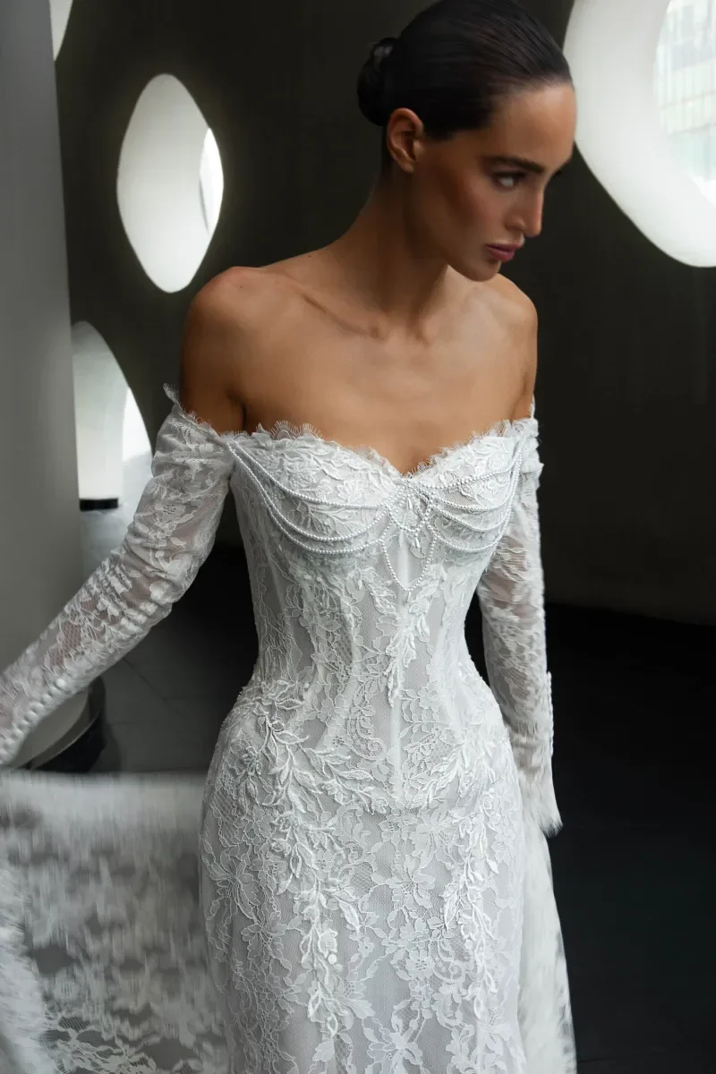 Pearl draped detailing on strapless corset bodice of Kaystine lace wedding dress by Natalia Romanova