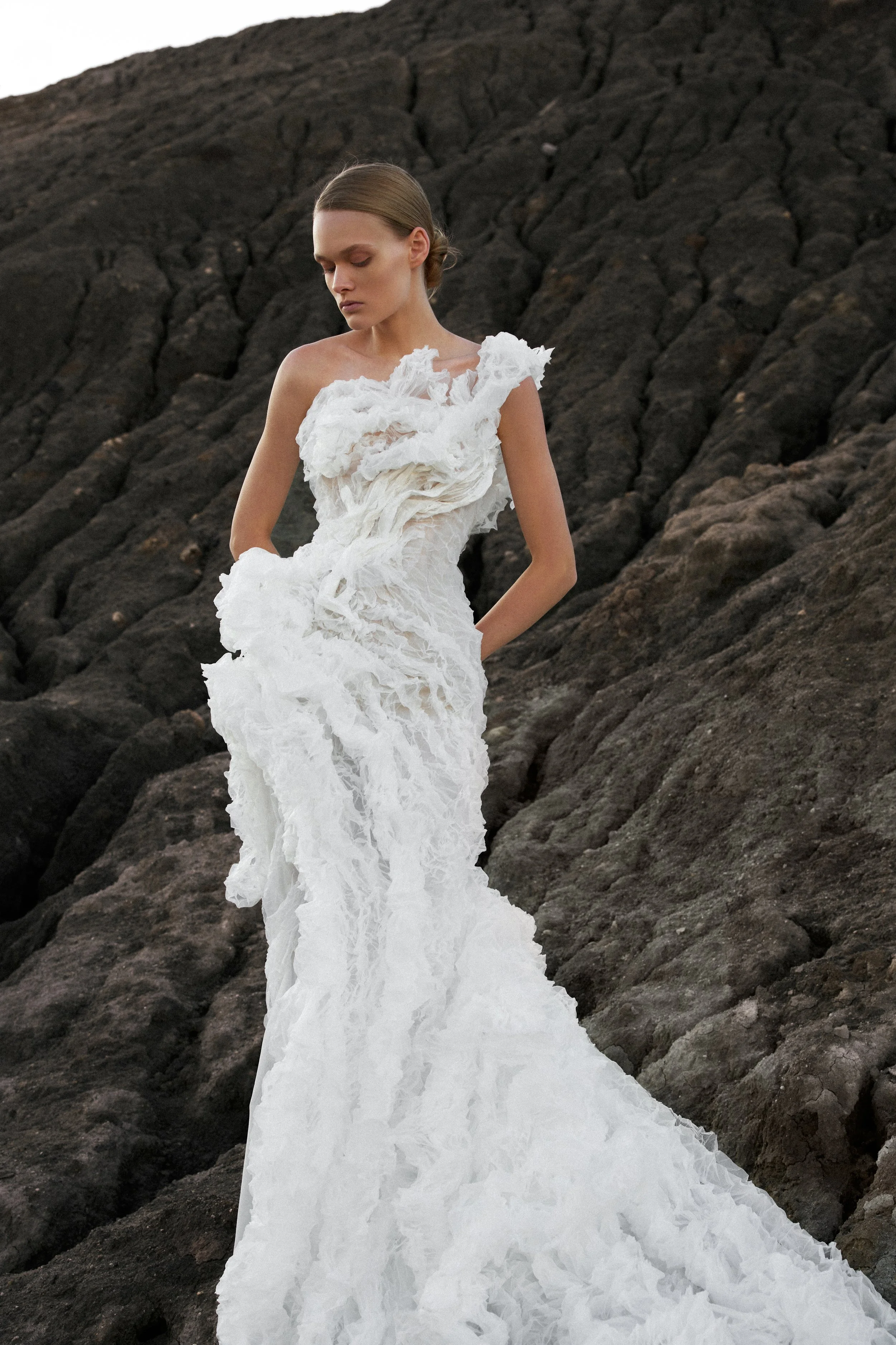 Lana Marinenko sculptural one-shoulder wedding dress with cascading ruffles, fitted silhouette, and sweeping train — a couture bridal gown for modern, fashion-forward brides