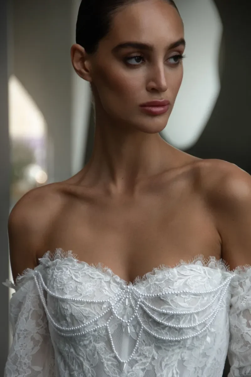 Pearl draped detailing on strapless corset bodice of Kaystine lace wedding dress by Natalia Romanova