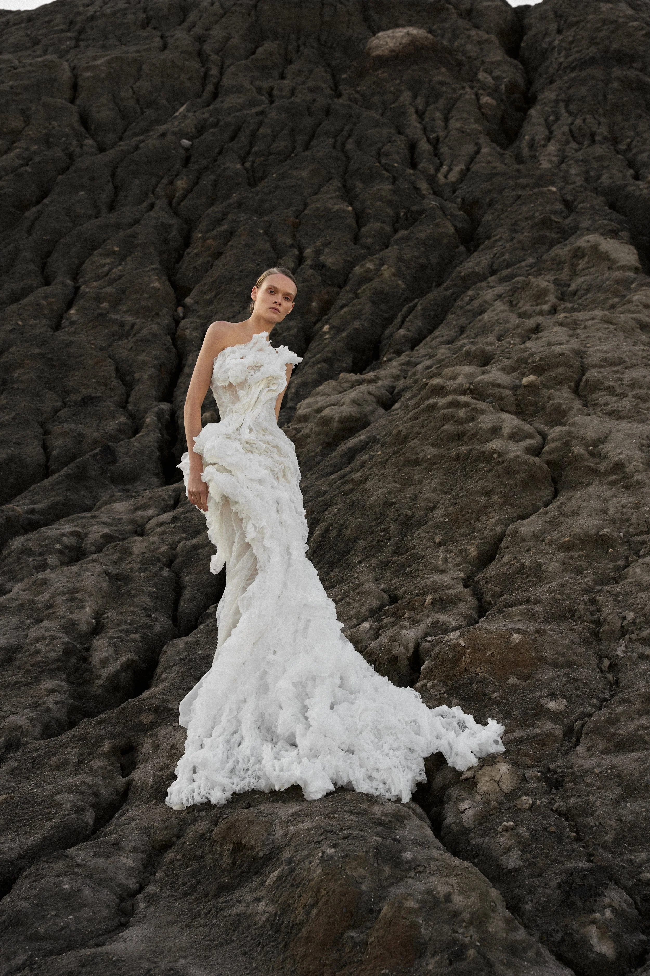 Lana Marinenko sculptural one-shoulder wedding dress with cascading ruffles, fitted silhouette, and sweeping train — a couture bridal gown for modern, fashion-forward brides