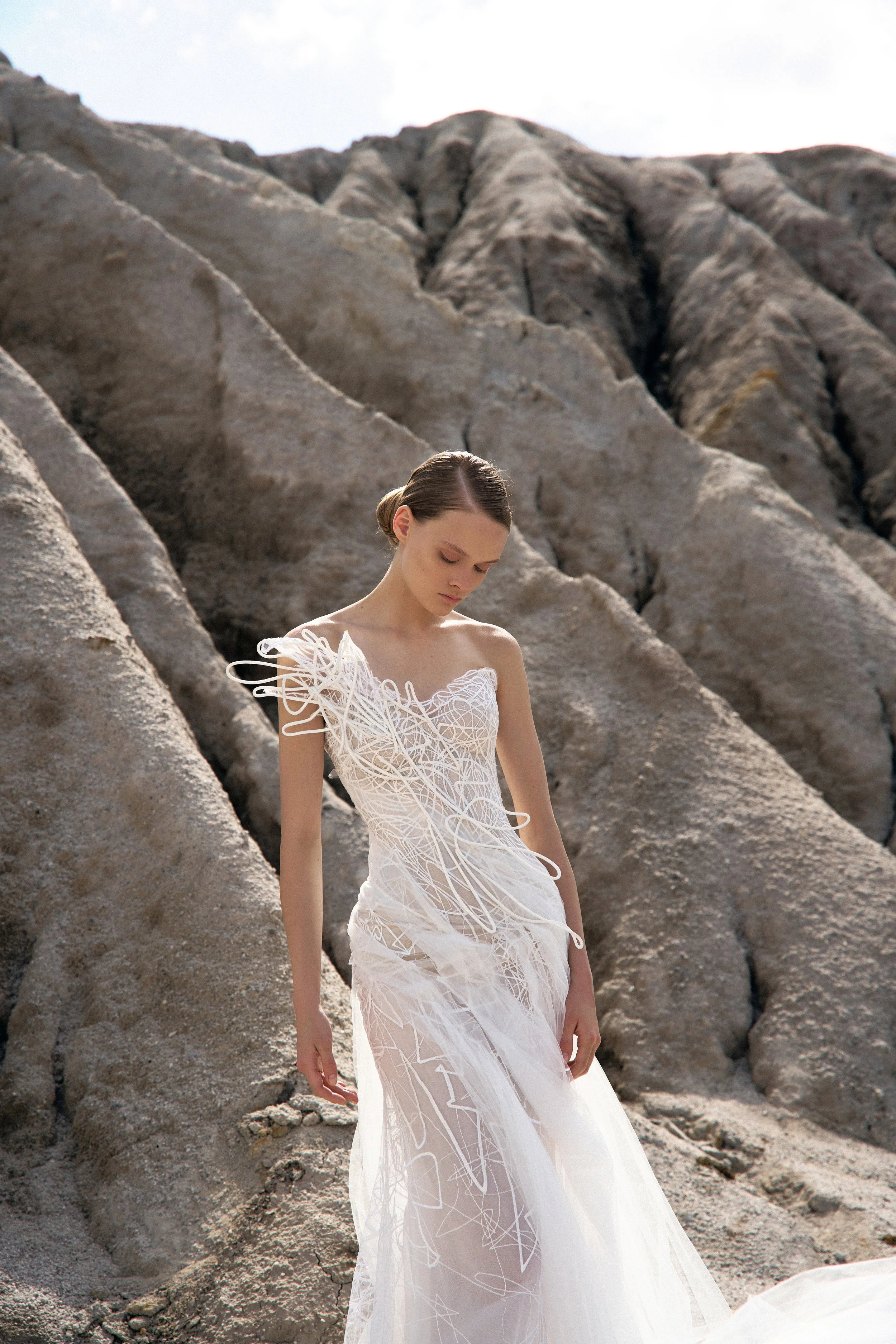 Heather by Lana Marinenko: a lace and tulle mermaid wedding dress with structured details. Effortless and elegant. Book your NYC appointment.