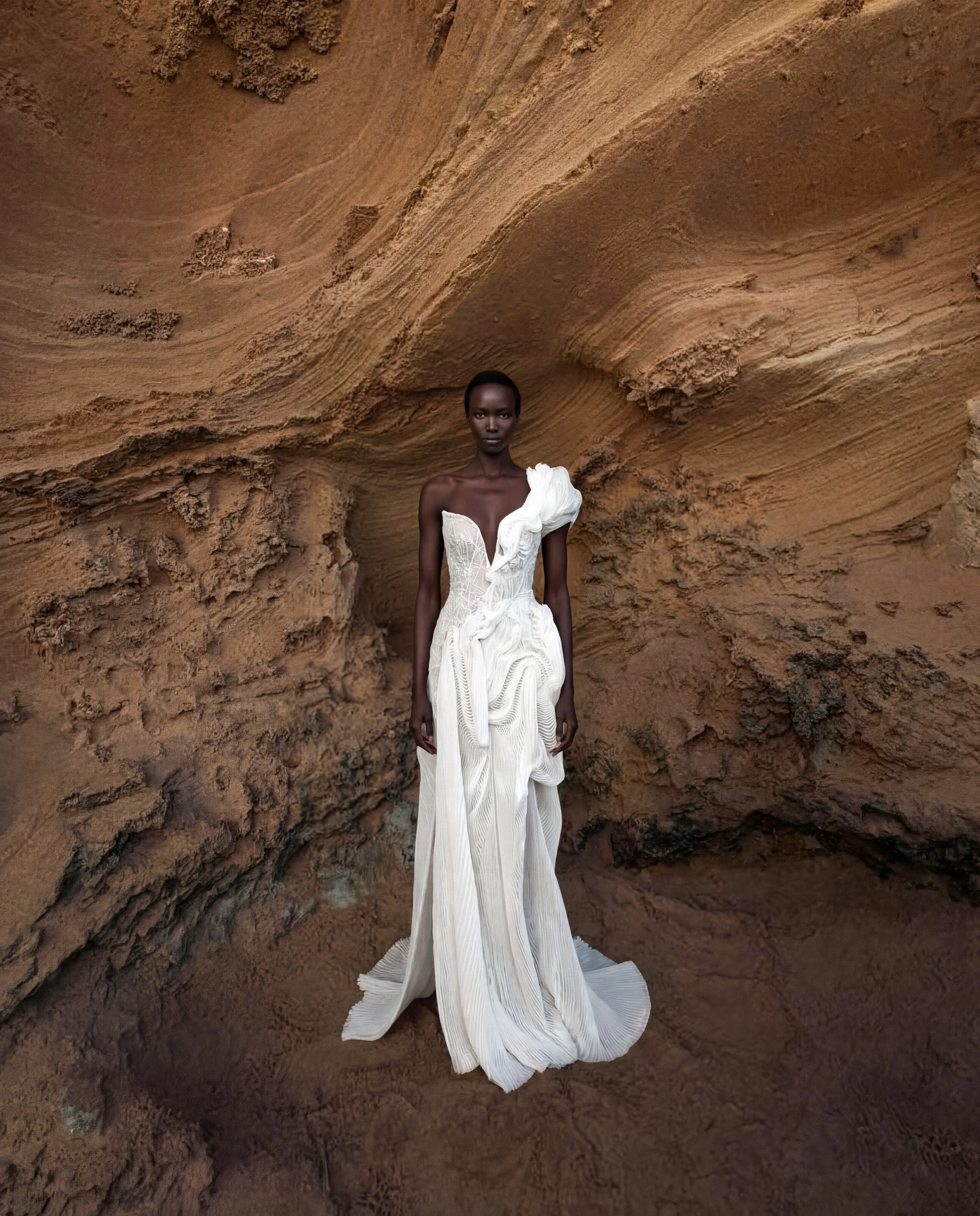 Asymmetrical wedding dress by Lana Marinenko made from pleated organza with a modern sculptural silhouette