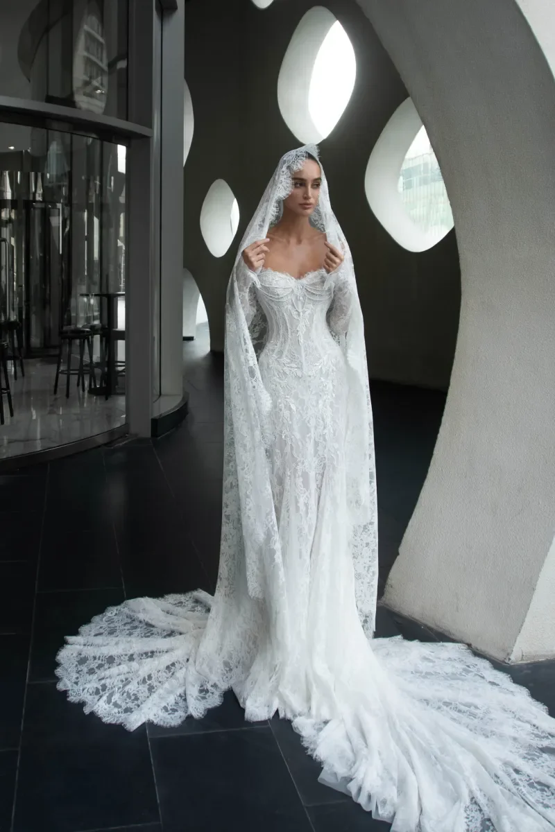 Bride wearing Kaystine floral lace mermaid wedding dress with pearl corset bodice in New York bridal boutique