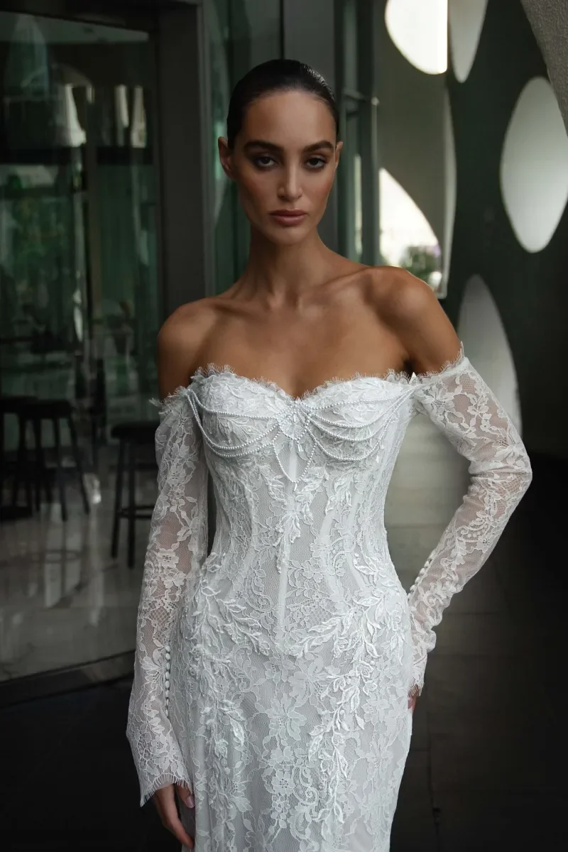 Pearl draped detailing on strapless corset bodice of Kaystine lace wedding dress by Natalia Romanova