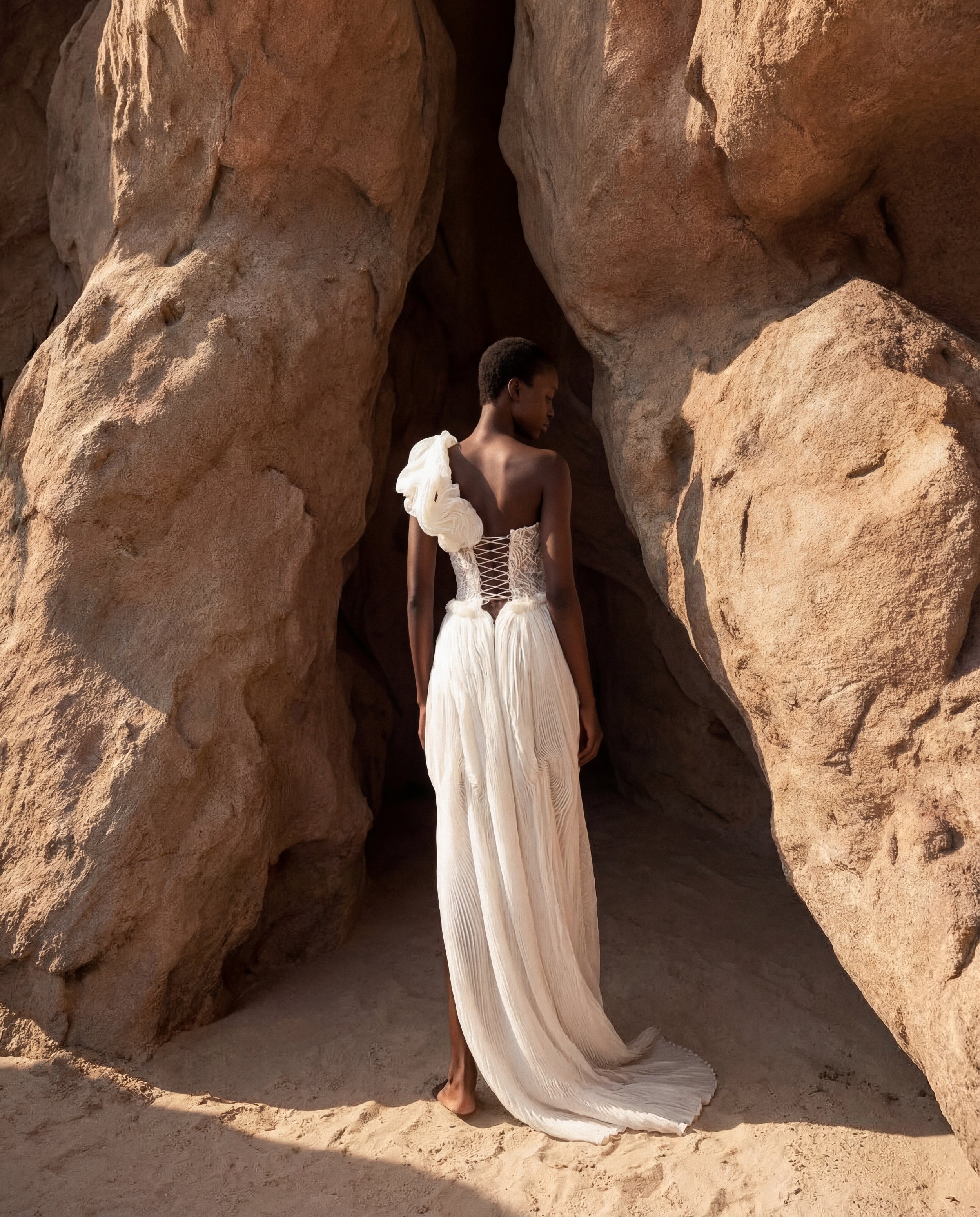 Asymmetrical wedding dress by Lana Marinenko made from pleated organza with a modern sculptural silhouette