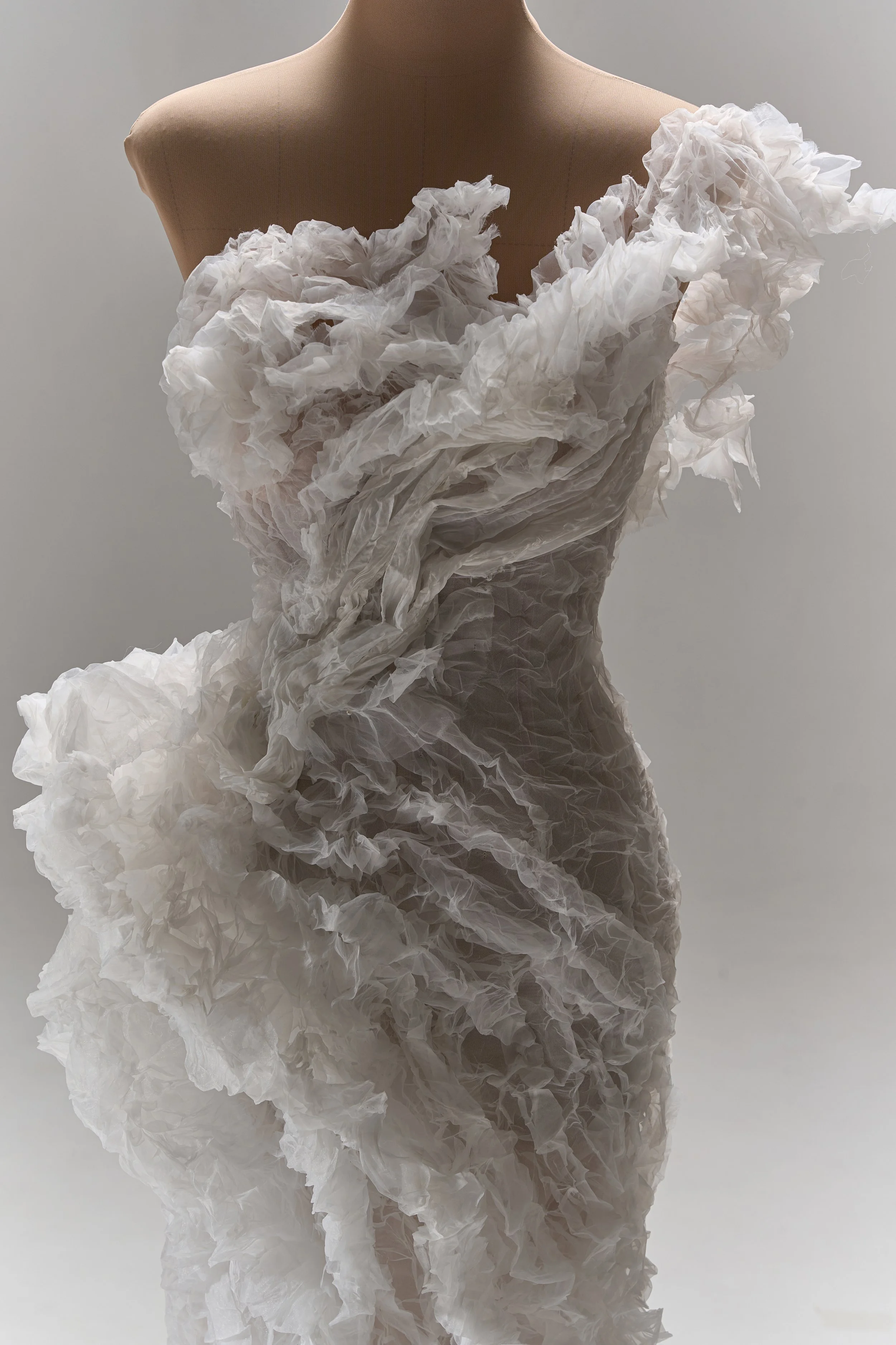 Lana Marinenko sculptural one-shoulder wedding dress with cascading ruffles, fitted silhouette, and sweeping train — a couture bridal gown for modern, fashion-forward brides