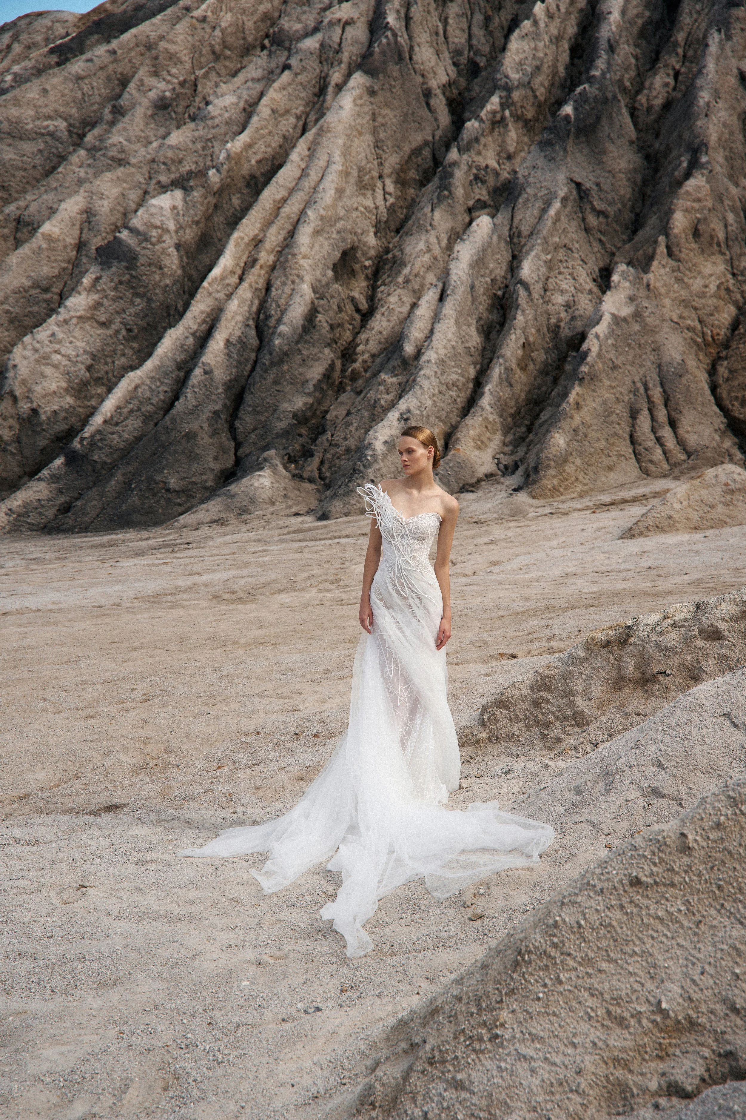 Heather by Lana Marinenko: a lace and tulle mermaid wedding dress with structured details. Effortless and elegant. Book your NYC appointment.