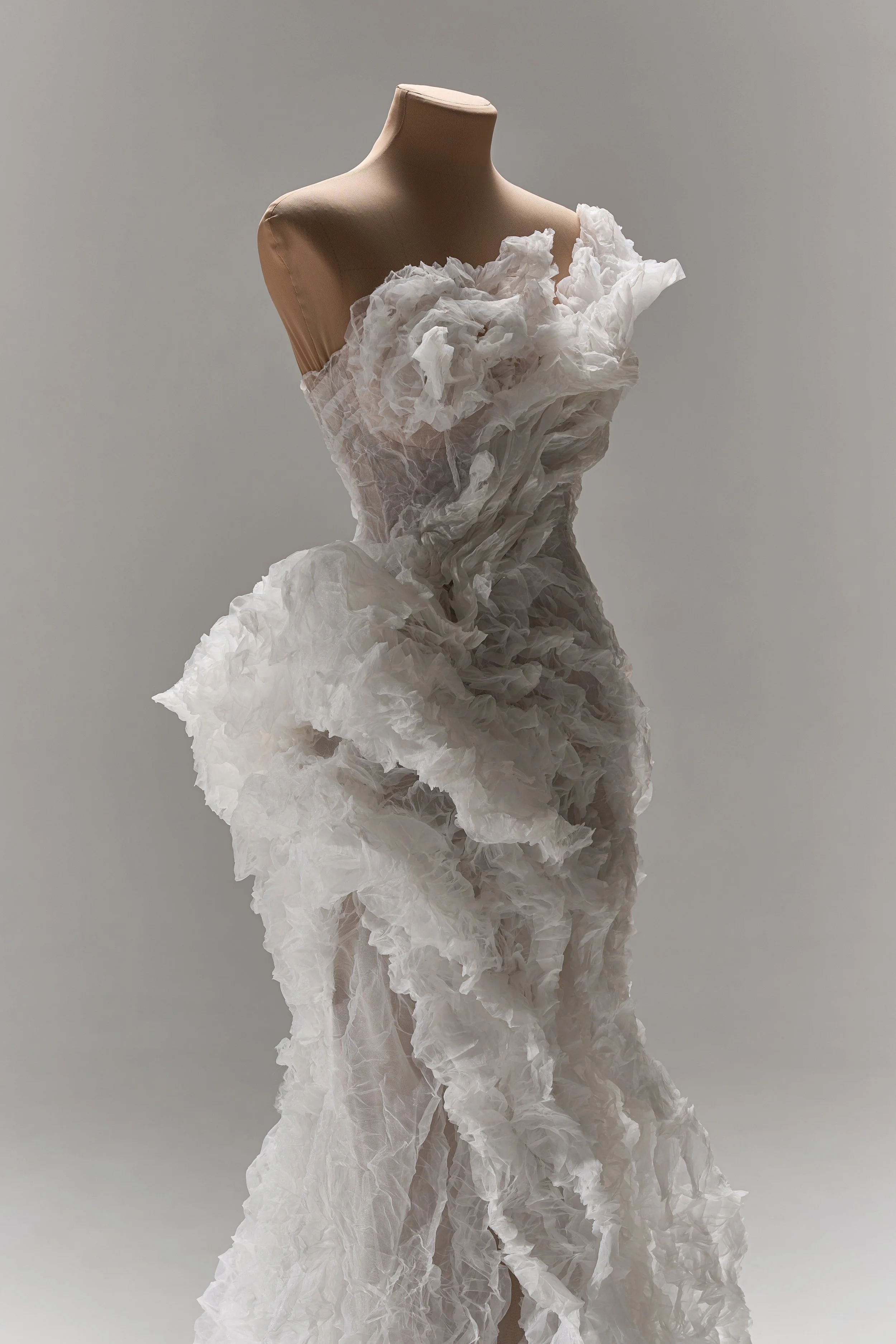 Lana Marinenko sculptural one-shoulder wedding dress with cascading ruffles, fitted silhouette, and sweeping train — a couture bridal gown for modern, fashion-forward brides