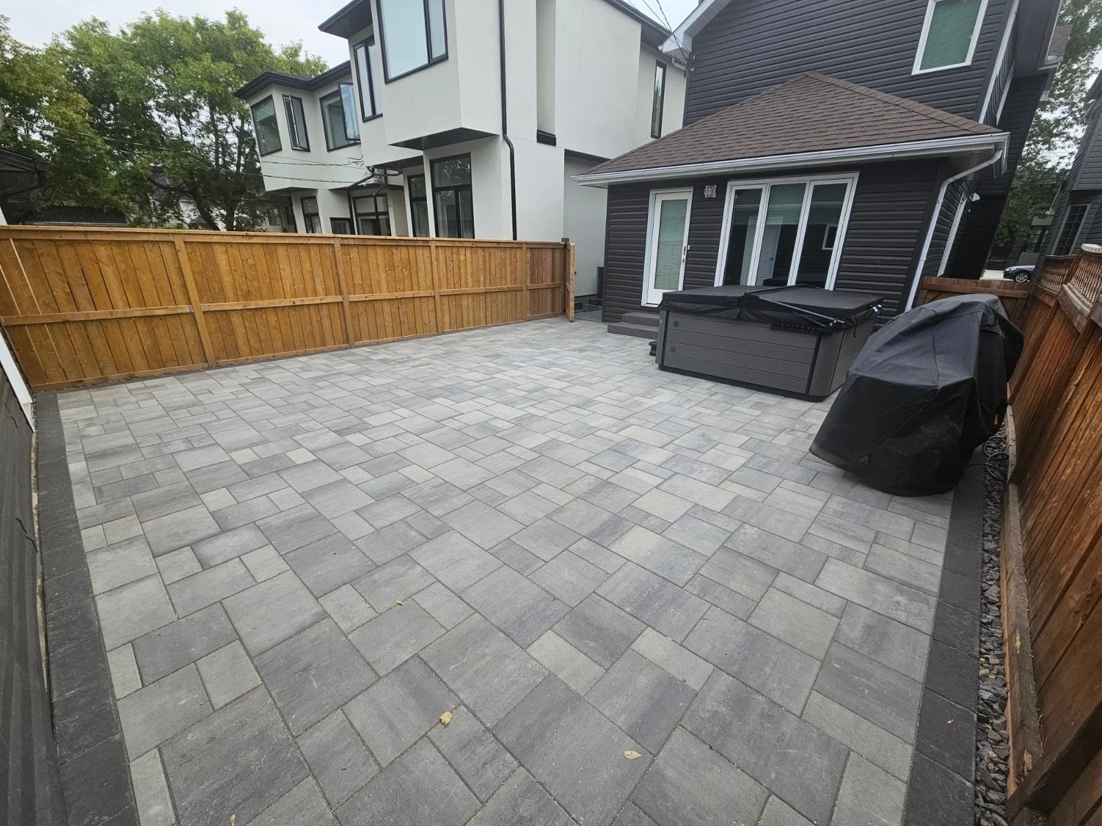Zeroscape back yard with Belgard pavers and precast cement steps.
