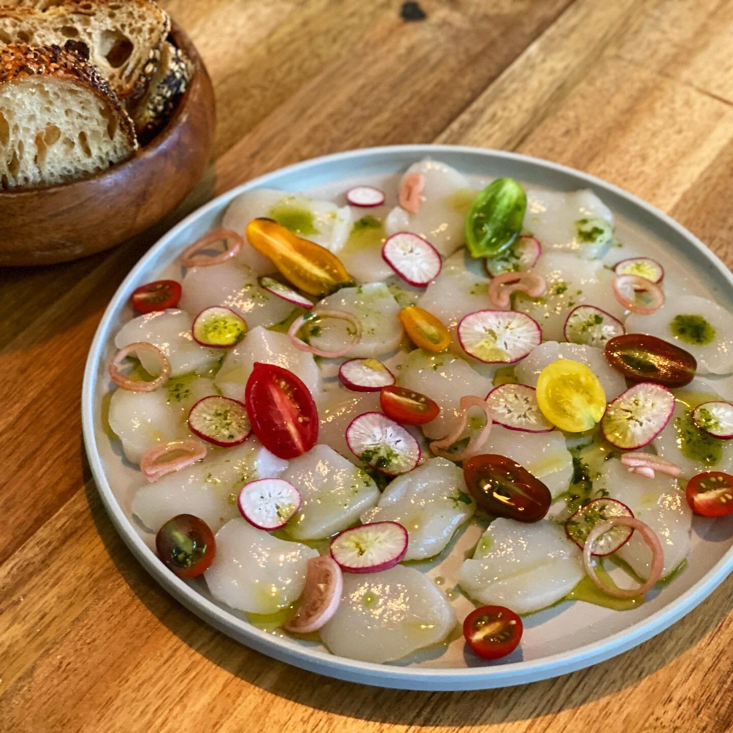 made a scallop carpaccio like an asshole. dry sea scallops sliced with some cherry tomatoes, radishes, quick pickled shallots, olive oil, lime, cilantro, sea salt. i made too much, a few pieces a person is enough for a dish like this. &ldquo;you live