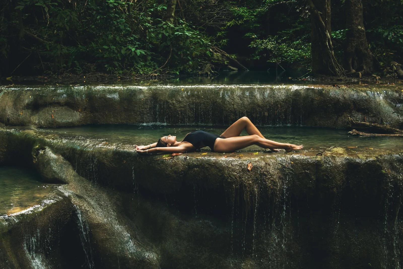 Canva - Young woman in the jungle with beautiful waterfall-1.jpg