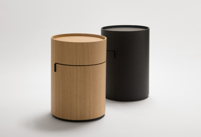 Moon nightstands featuring cylindrical forms in natural oak wood and black finishes, each with a minimalist drawer detail, displayed on a white background.