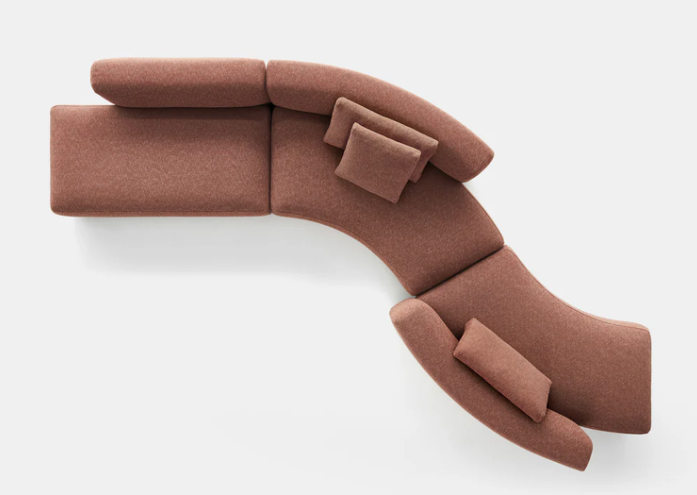 Cosy Curve modular sofa in dusty rose upholstery photographed from above, showcasing its organic curved configuration with sectional pieces and cushions arranged in a flowing, sculptural layout on a white background.