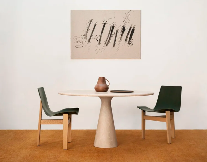 Minimalist marble "M" table by Angelo Mangiarotti, featuring a circular top resting on a tapered, hyperboloid central base.