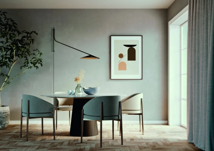 Glifo wall lamp with black articulated arm and cone-shaped shade mounted above a modern dining table with teal and cream chairs, displayed in a contemporary dining room with gray walls and herringbone flooring.