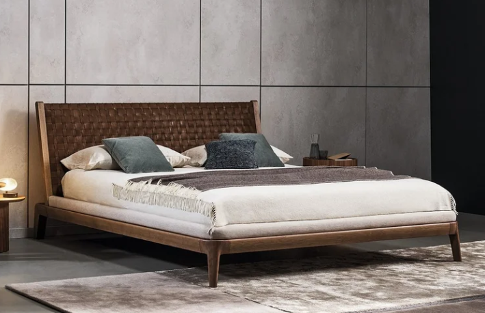 Honeymoon bed by Mauro Lipparini with solid American walnut frame and woven full-grain leather headboard in a refined master bedroom.