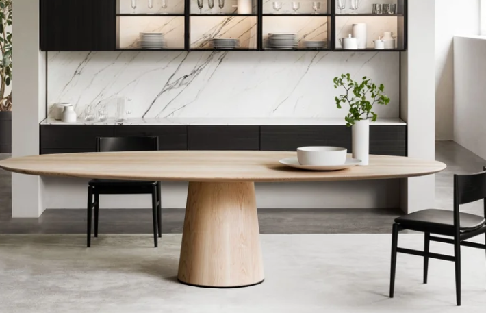Materic dining table by Piero Lissoni with marble top and metal base in a stylish dining room interior.