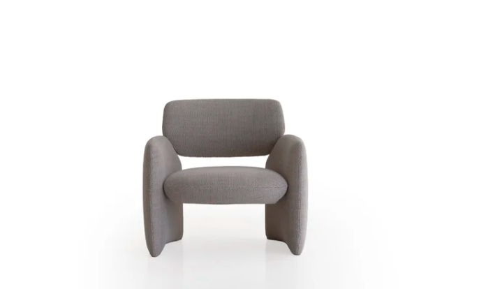Arnaldo lounge chair in gray upholstery featuring a sculptural design with curved armrests that flow seamlessly into the base, creating a modern low-profile silhouette on a white background.