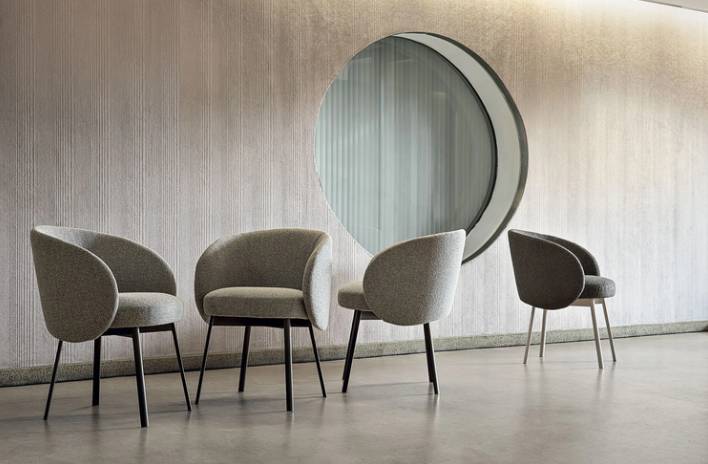 Hug dining chairs by Gabriele e Oscar Buratti with a curved upholstered backrest and refined contemporary silhouette.