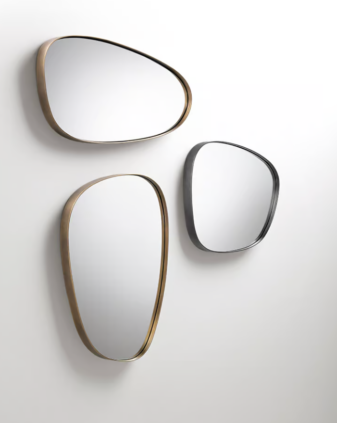 Syro mirror by Emilio Nanni featuring three reflective panels with Orbitale DeLabré brass structures hung on the wall.