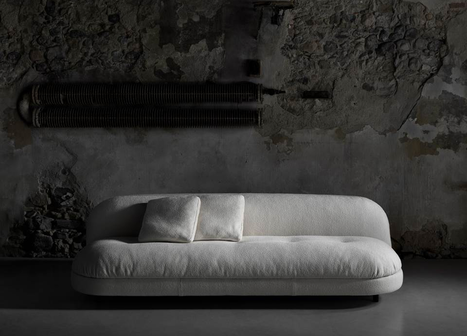 Gala Sofa with elegant upholstered form and adjustable steel feet