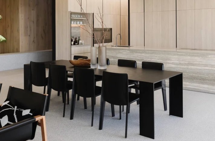 Metallico dining table by Piero Lissoni in solid metal construction in a contemporary formal dining room.