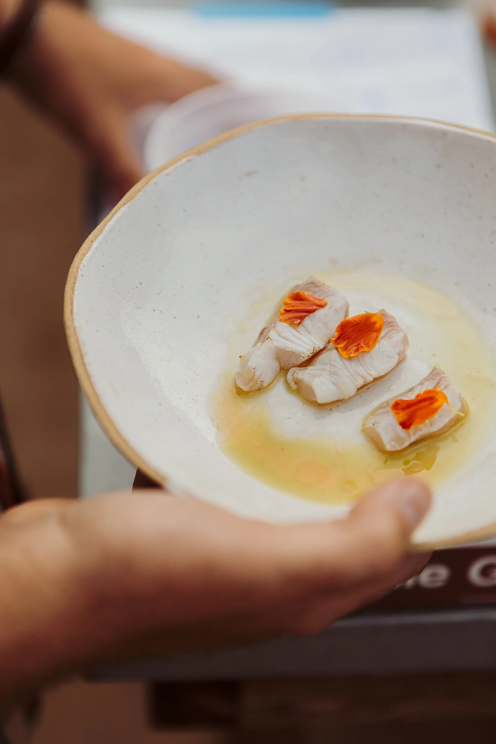 Chef Aidan Owens featured in Food & Wine sustainable seafood stars article preparing a bycatch‑inspired dish