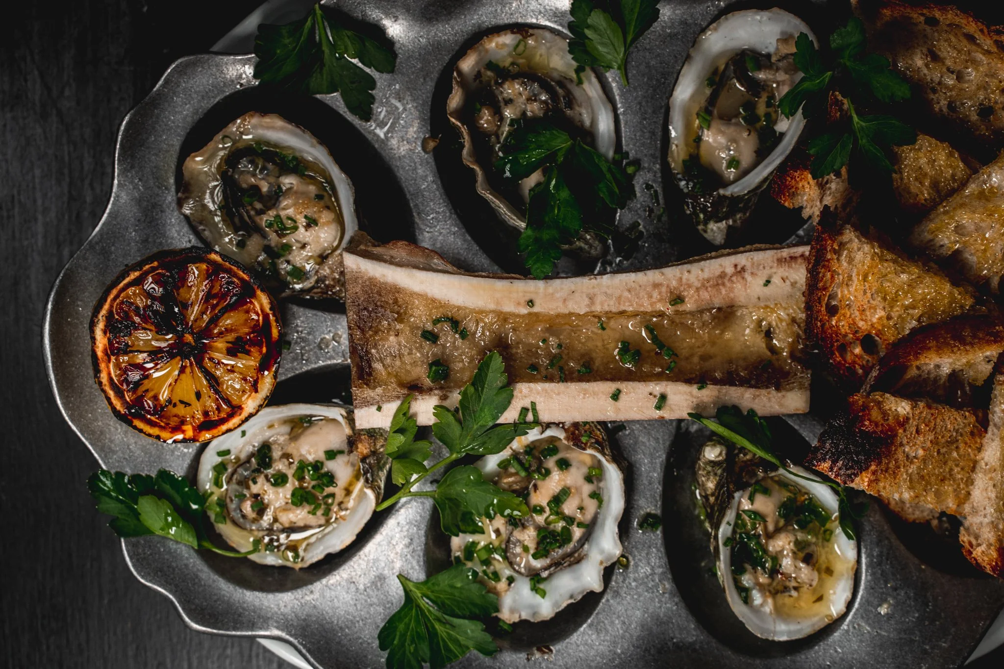 Chef Aidan Owens preparing oyster toppings for raw oysters in Tasting Table