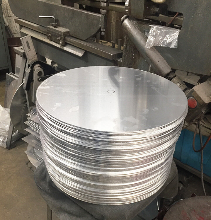 Flat discs of aluminum ready to be spun.