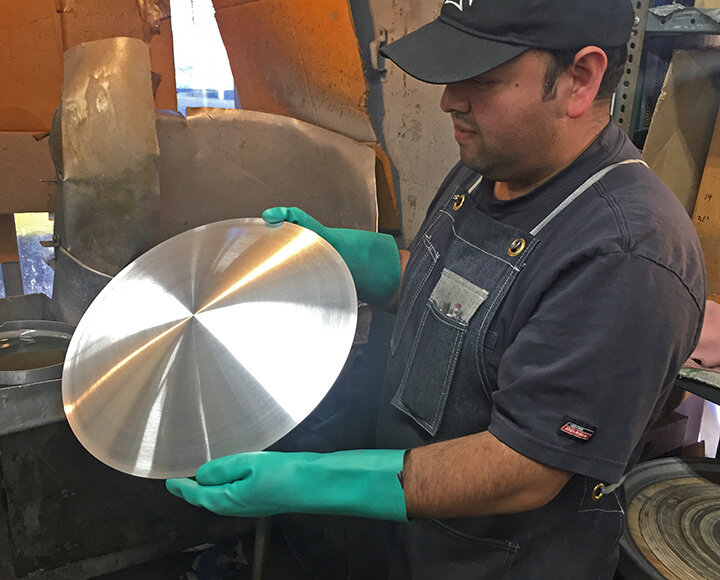 Jose holds a beautiful, finished Moon disc.