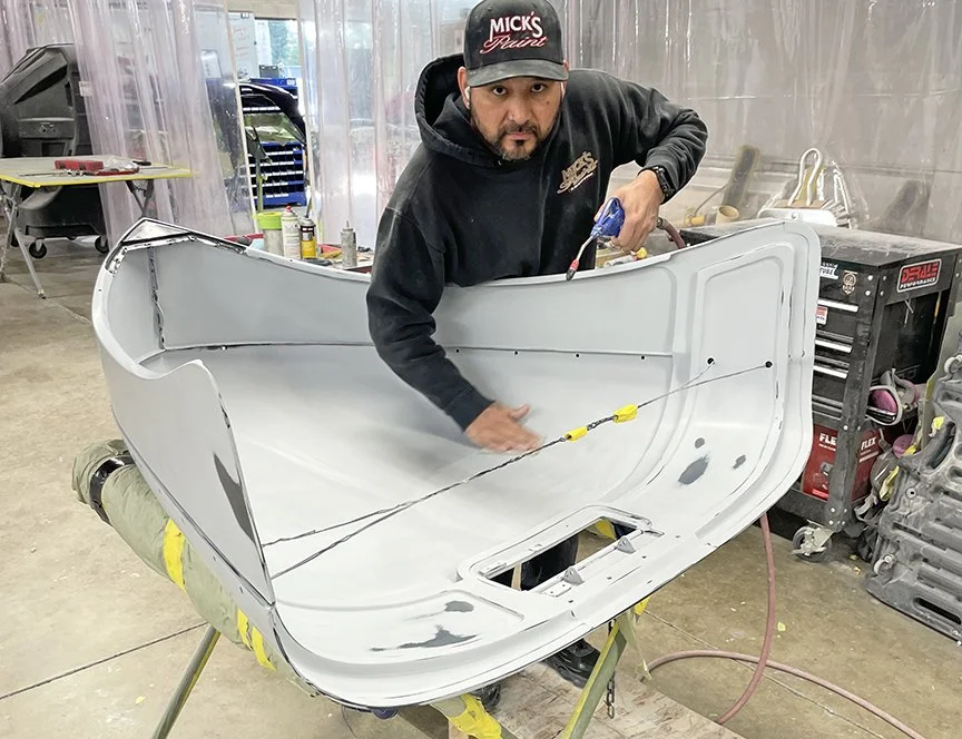Esteban preps the underside of the hood