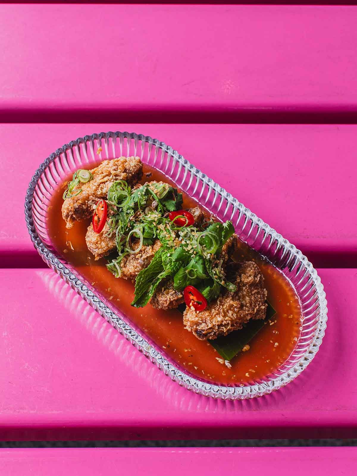 Ultra crispy on the outside, succulent on the inside, and drenched in a bold, savory sweet chili glaze. Finished with fresh herbs, scallions, and sliced chilies, these wings bring the ultimate crunch and flavor kick to your table. Ready to elevate yo