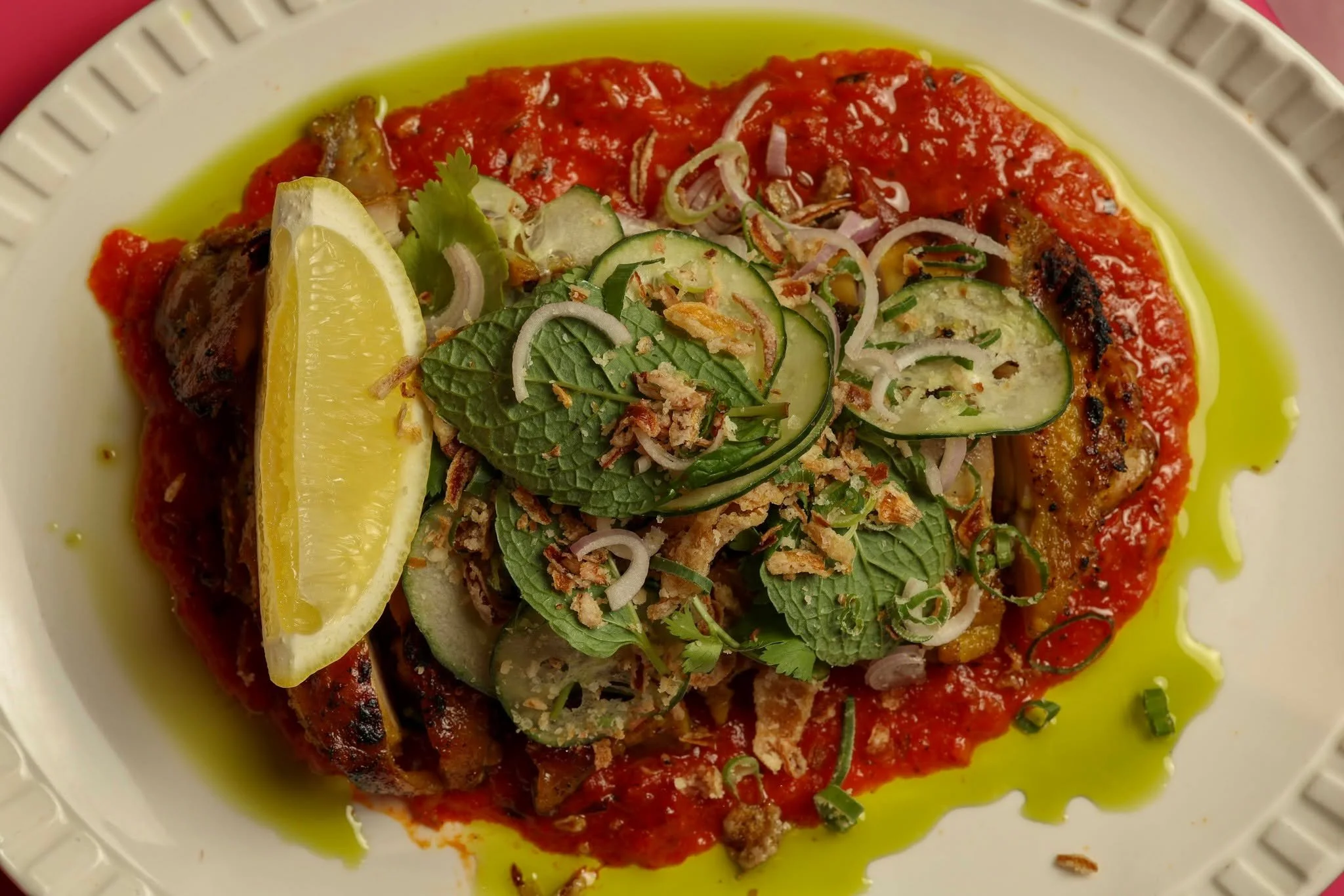 Charred grilled chicken resting on vibrant house chili paste, layered with fresh mint, cucumber ribbons, and crispy shallots. Fresh, bold, and packed with punchy crunch.

Claim your table today: https://www.sevenrooms.com/.../reservations/create/sear