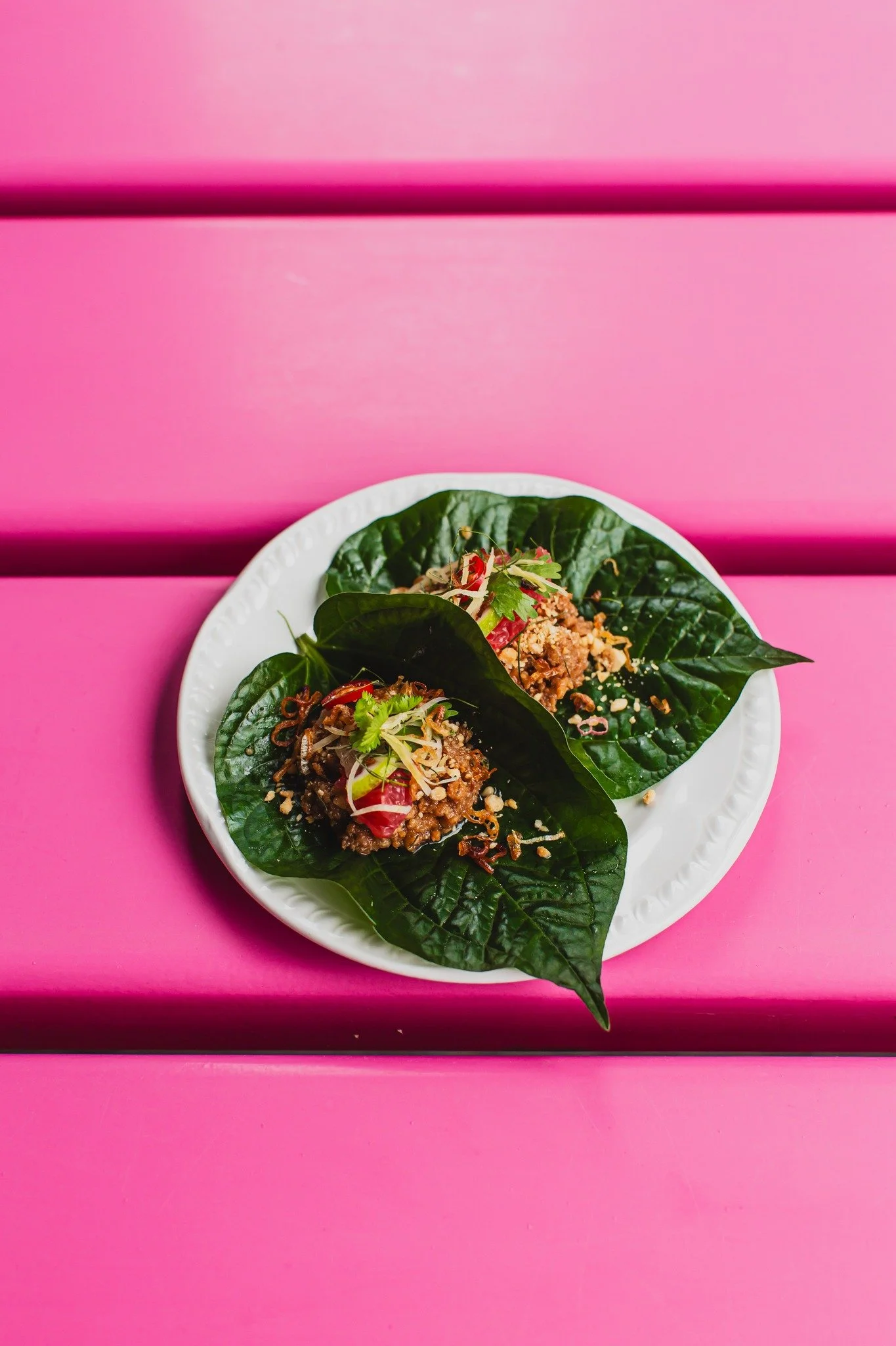 A full sensory explosion in a single bite. Peppery wild betel leaves loaded with spiced chicken mince, toasted peanuts, ginger, chili, and fragrant herbs. The essential starter for your next visit.

Reserve your table here: https://www.sevenrooms.com