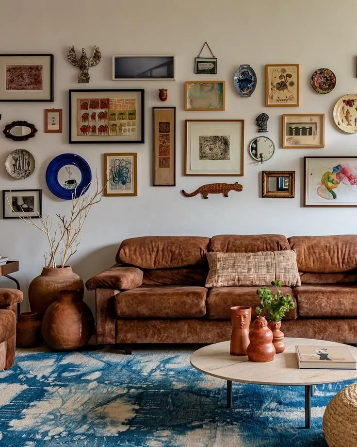 Colourful gallery wall in a hallway featuring mismatched frames and collected artwork