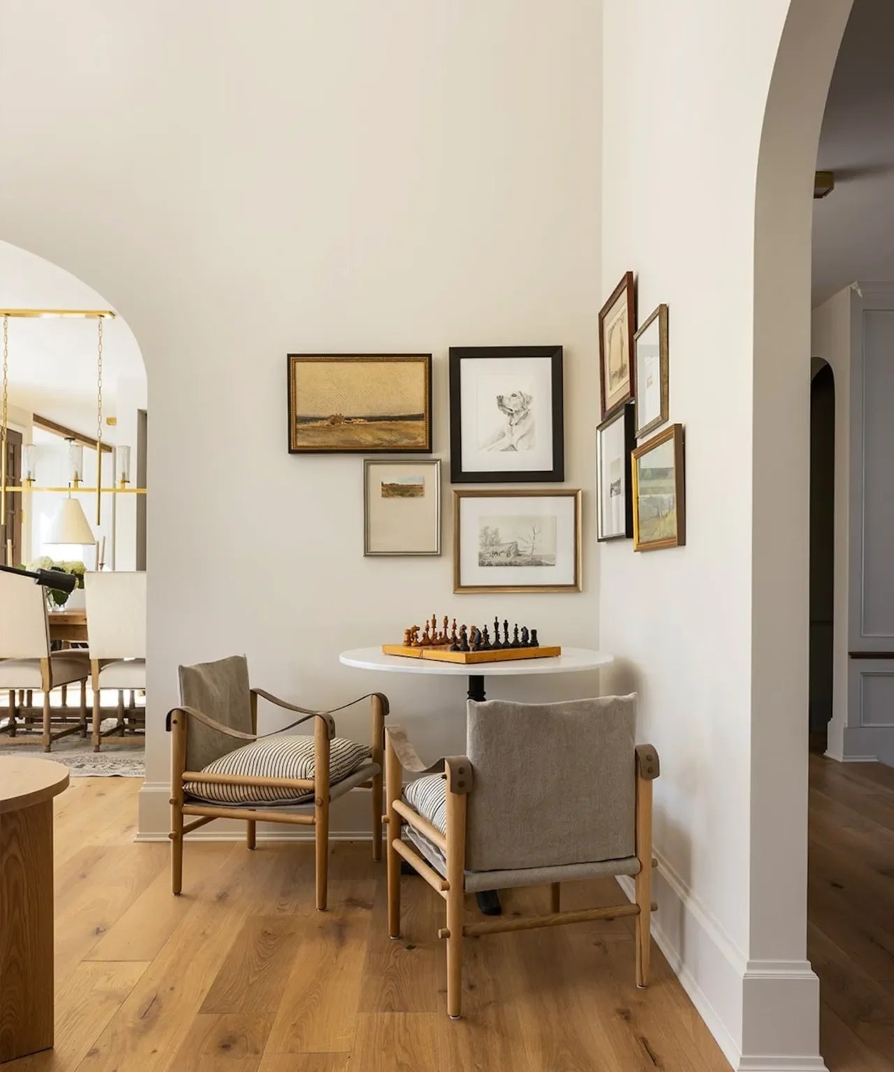 Eclectic gallery wall with vintage textiles, paintings, photographs and decorative objects