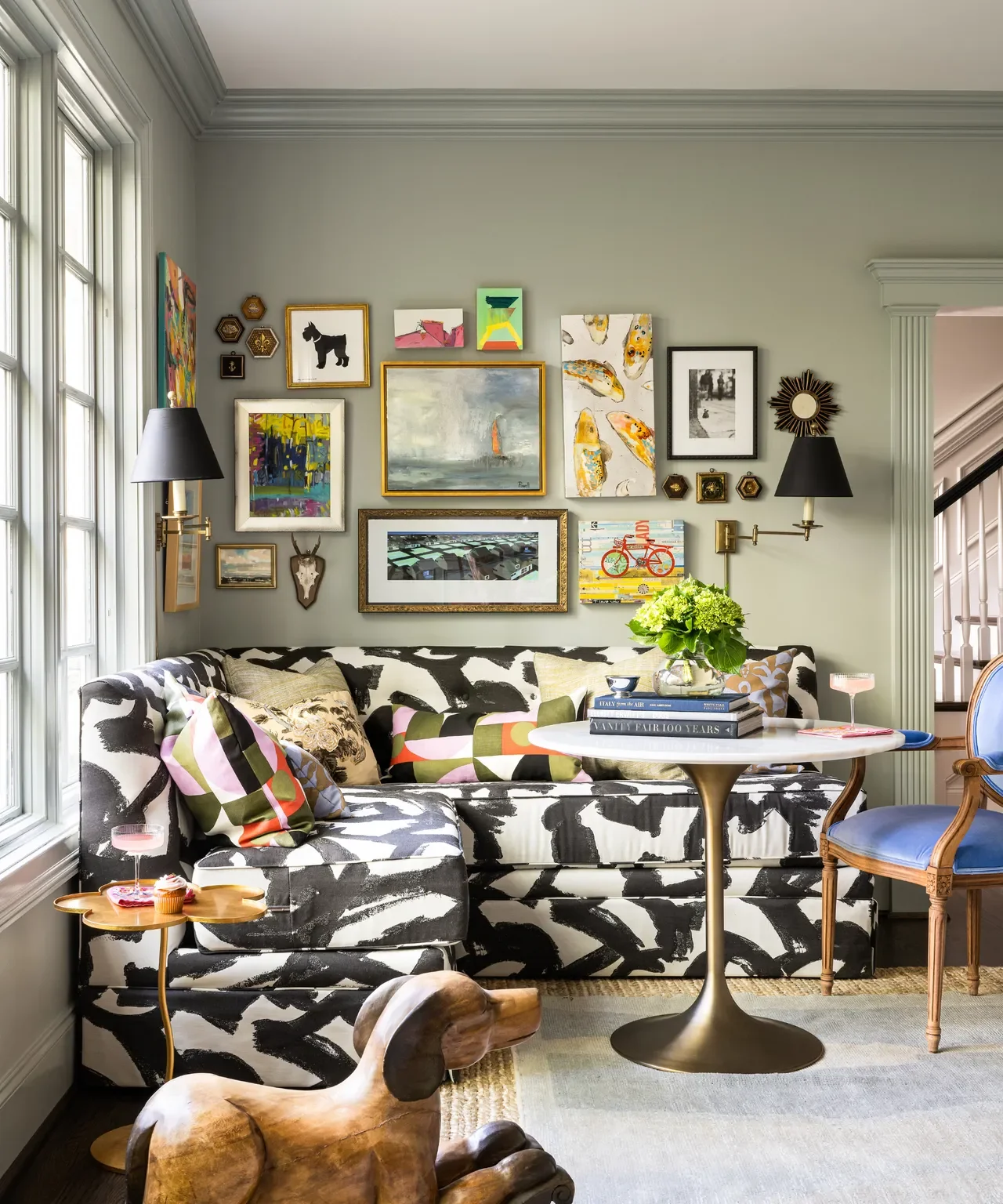 Personal gallery wall displaying paintings, postcards, photographs and children’s artwork