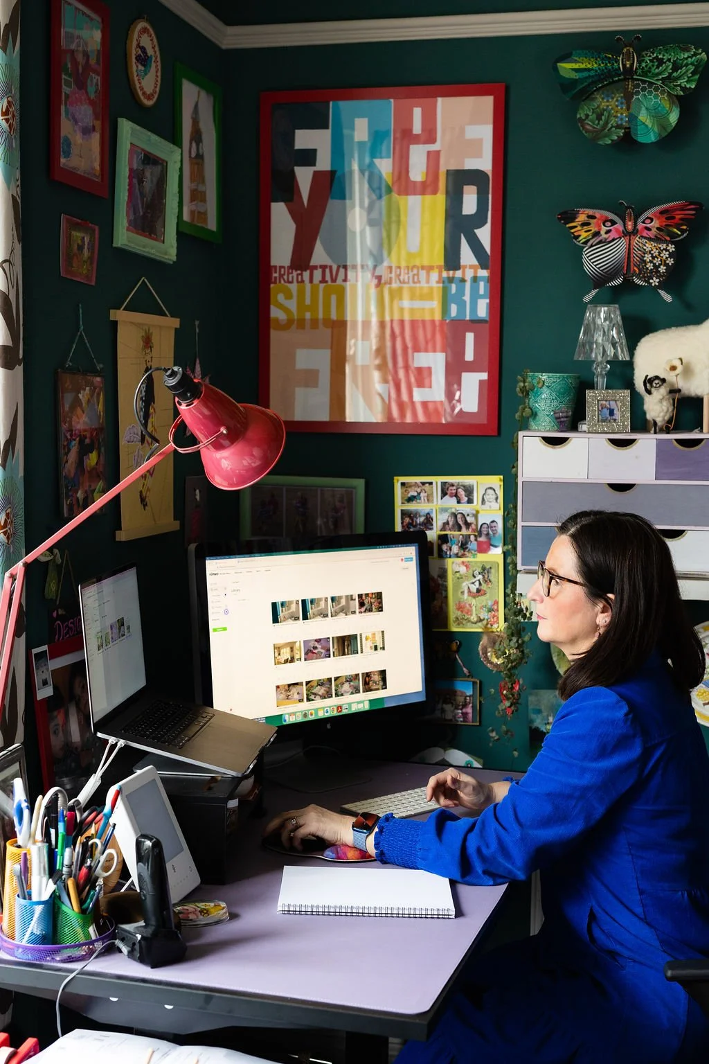 Eclectic gallery wall with colourful artwork, family photographs and personal treasures