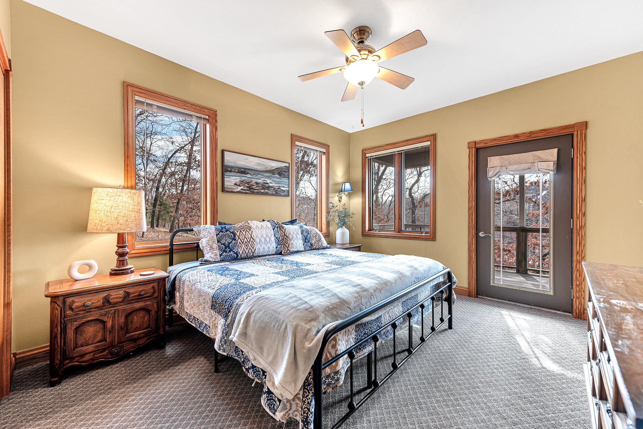 Bedroom with lake views and access to the deck.