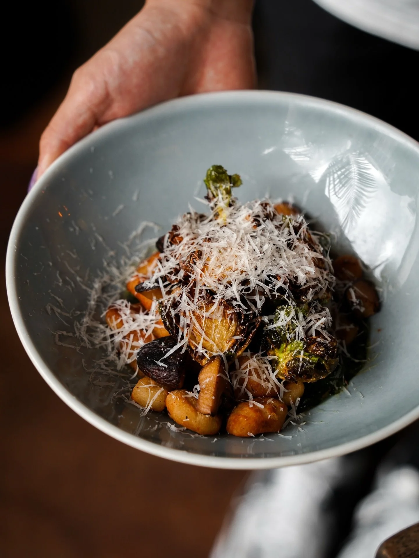 Pillowy potato gnocchi coated in creamy spinach sauce, layered with earthy mushrooms, crisp brussels sprouts, and finished with parmesan.

Make a reservation at nassimhill.com.sg.