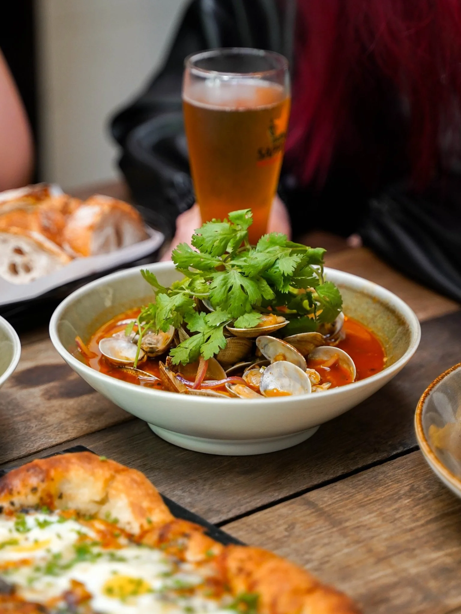 Tender lala clams simmered in a white wine sauce with sriracha to give it a kick, finished with fresh cilantro for a squeeze of brightness.

Best enjoyed with toasted baguette on the side, for soaking up every last bit of that sauce.

Make a reservat