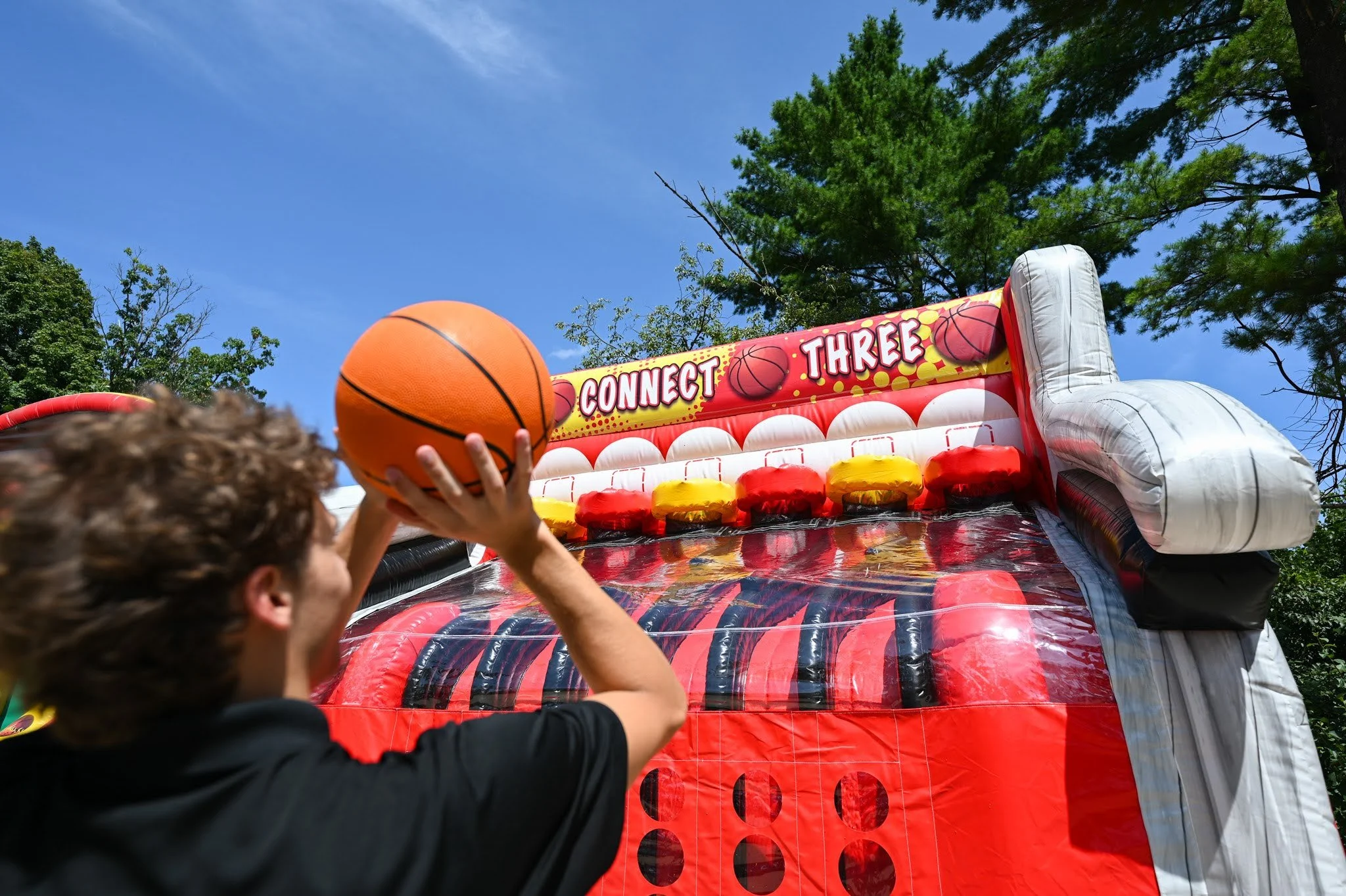 Boys climbing on the inflatable course at
