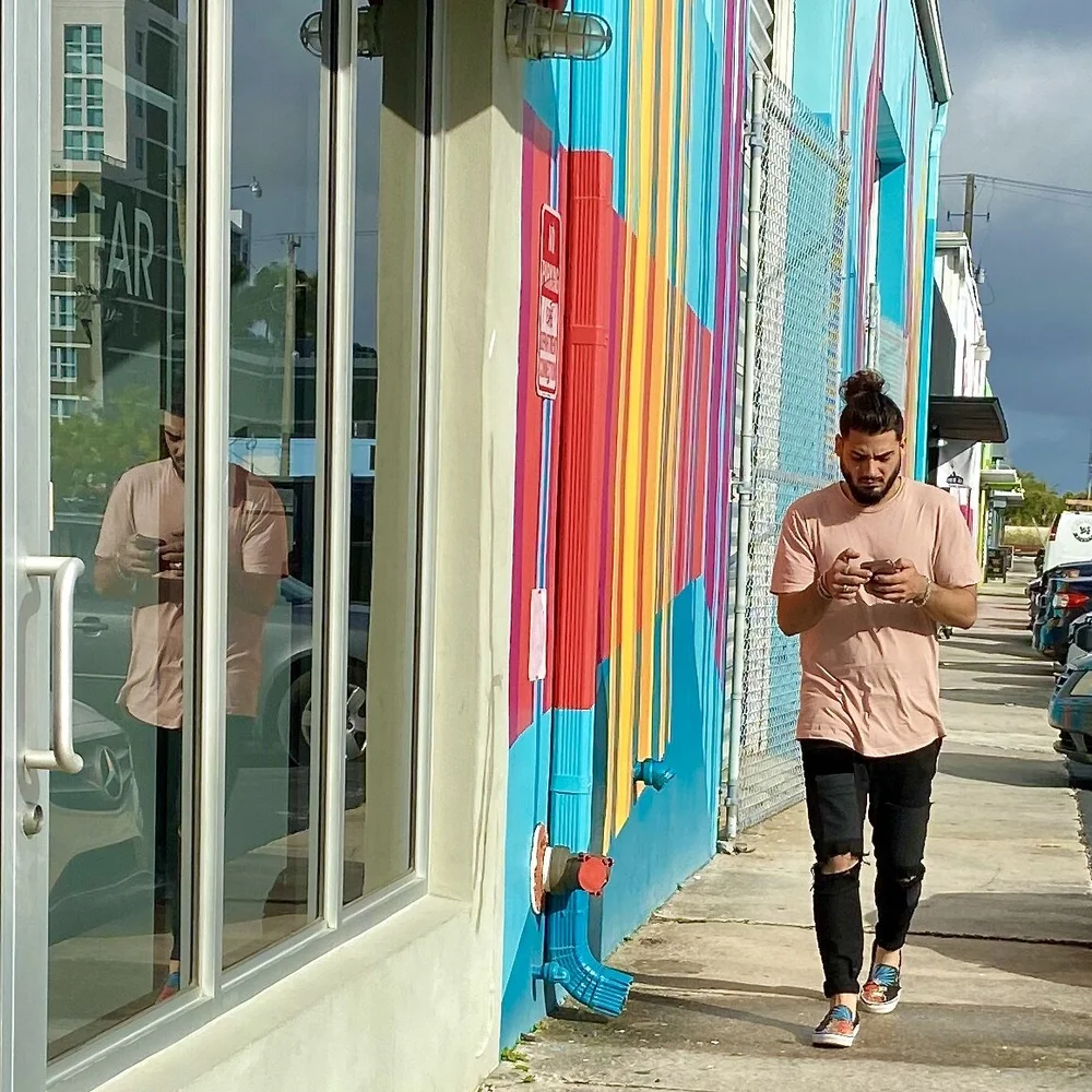 Man in Pink Tee w Phone.jpeg