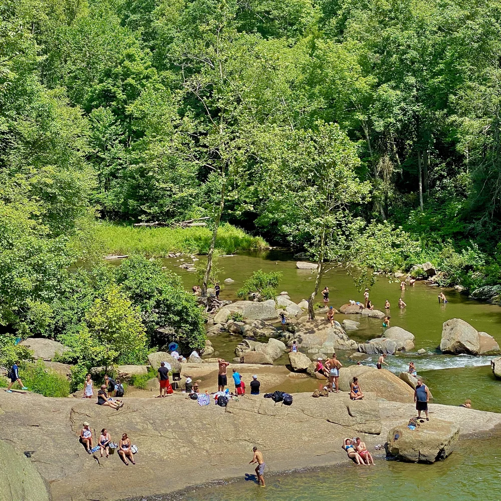 Sunbathers on boulders in river.jpeg