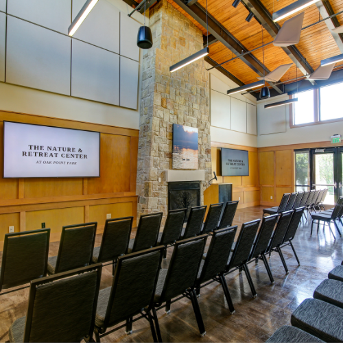 Rows of chairs set up in the ballroom for a corporate presentation at a corporate retreat