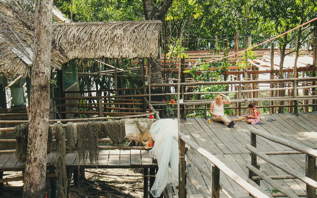   A fishing hut surrounded by jungle and a river  