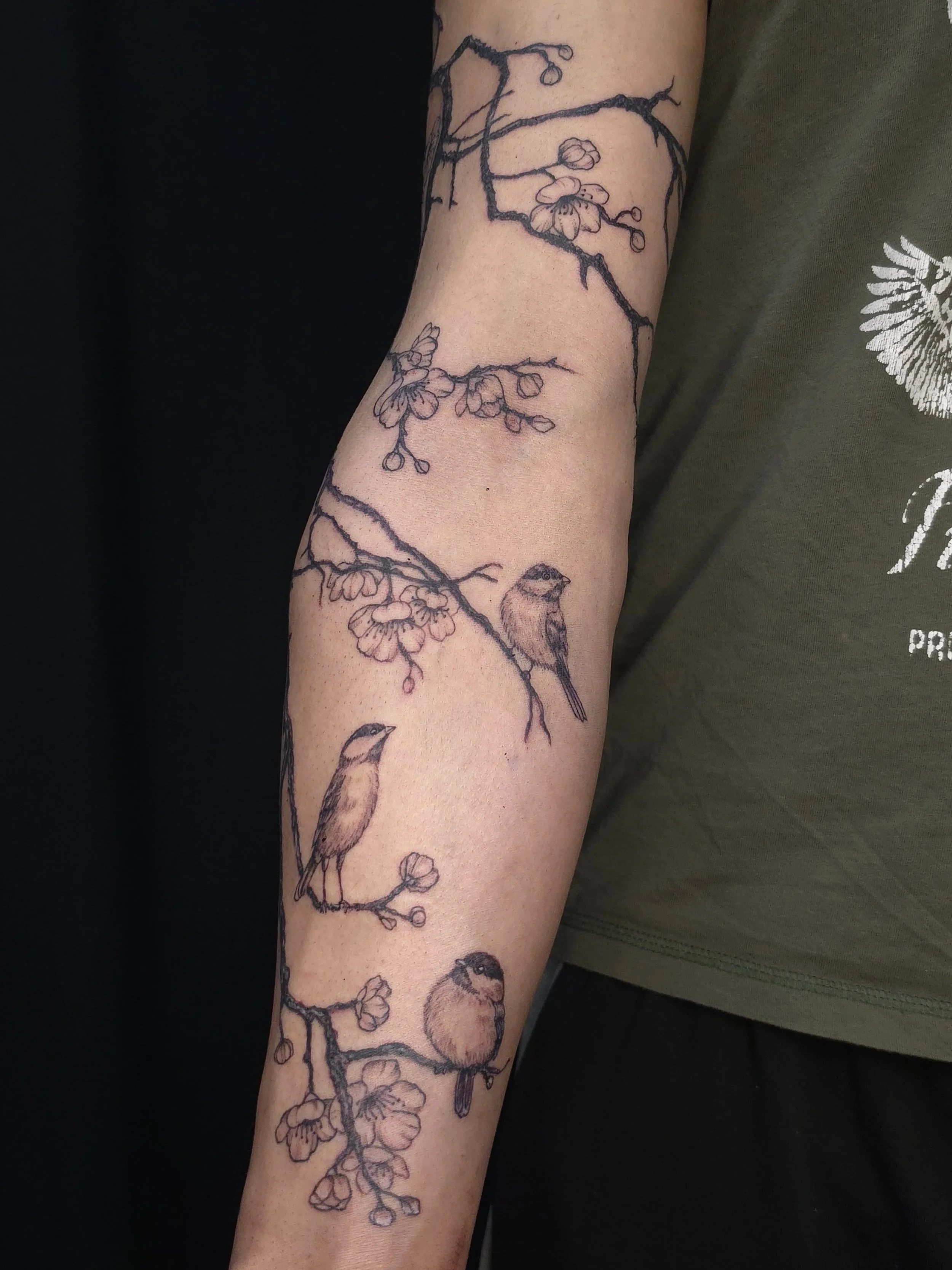 Cherry blossom tree branch with some sparrows representing specific people in his life. Super dope idea!
