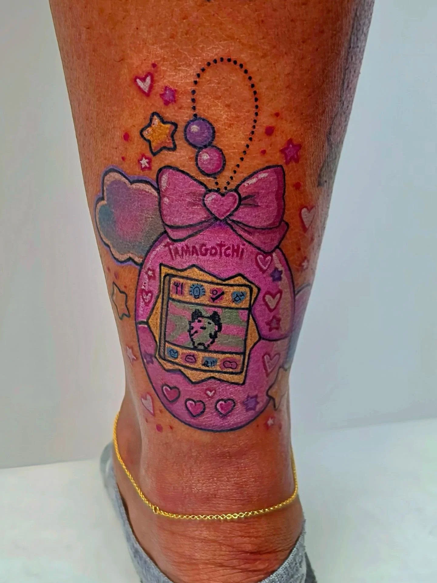 ​A little digital pet to hold onto forever. 👾 I had so much fun pulling the colors for this Tamagotchi piece and adding onto Bianca's cute tattoos colection. One of my favorite things about tattooing is finding the perfect palette that pops perfectl