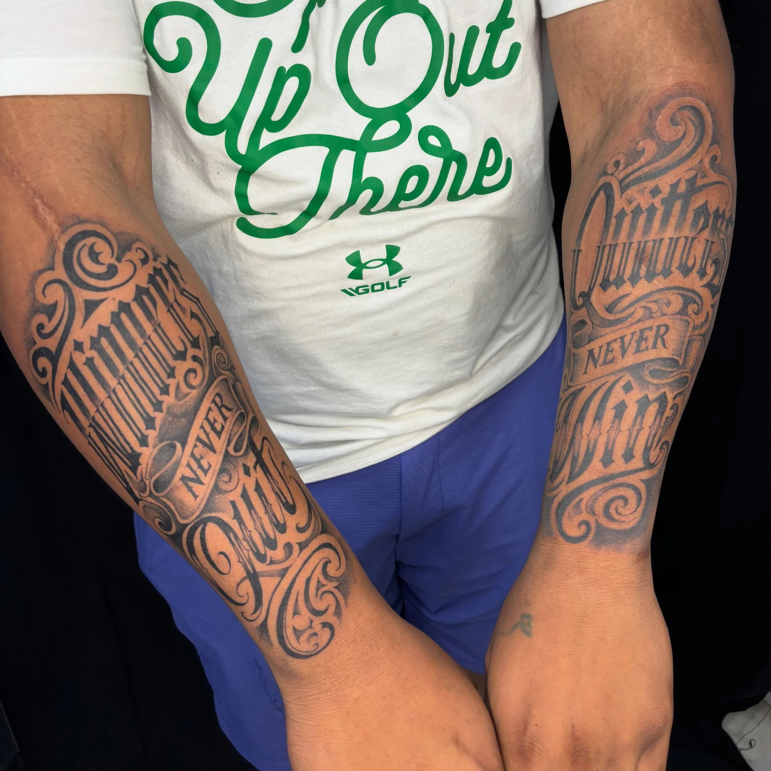 Asymmetrical symmetry script tattoos for Emmanuel. A slogan of his contracting business. He initially wanted to get a script from shoulder down to his wrist. But since he already had script on both arms, we decided to go with this design, and I&rsquo