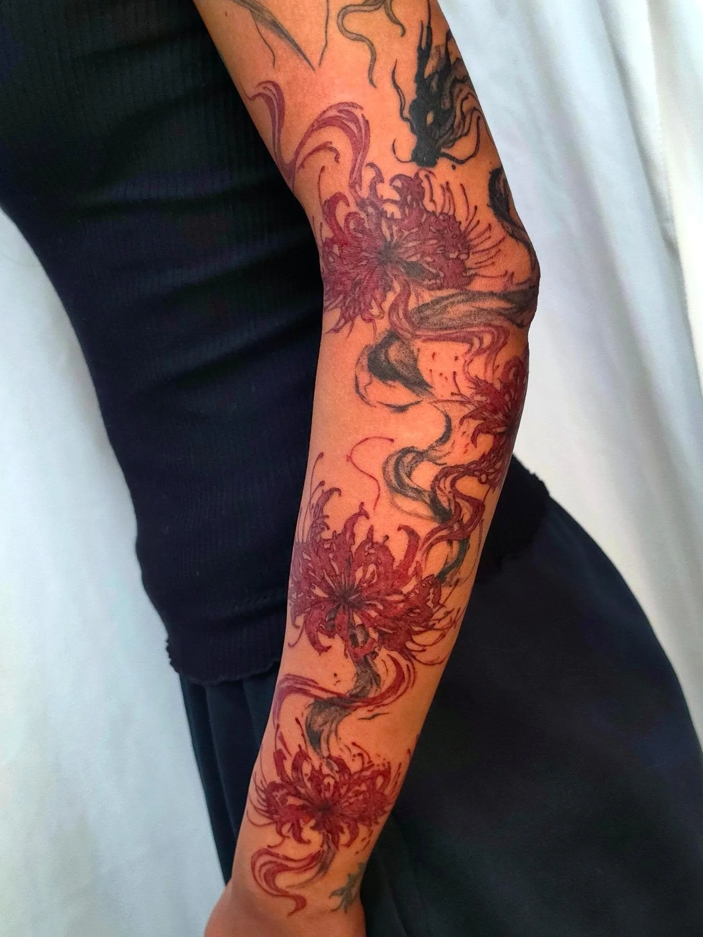 Brush style dragon tattoo with spider lilies arm sleeve filler. Absolutely obsessed with this piece! Love how the dragon integrates with the flow of the flowers as well as the arm. 

Fill out the Form in my bio to book!
Booking for:  SEPTEMBER &amp; 